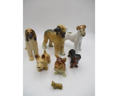 A collection of seven ceramic dogs including a Sylvac Afghan Hound, Copper Craft, Corgi Wade Mini, West German etc