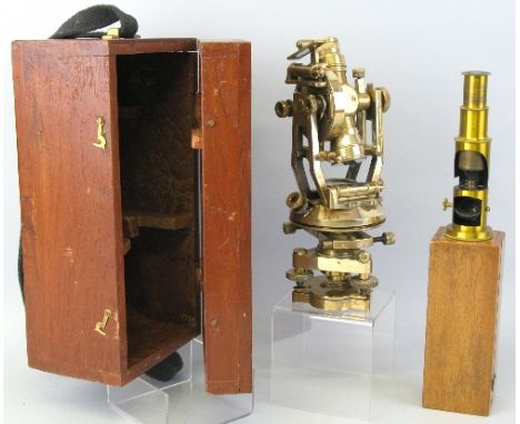 A reproduction brass theodolite, 25cm high, in fitted hardwood case and a lacquered brass monocular field microscope, 15.5cm 