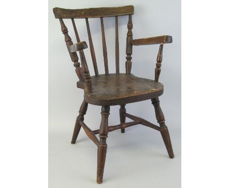 A child's stick back armchair with undulating crest rail, turned supports and legs and H-stretcher, traces of floral painting
