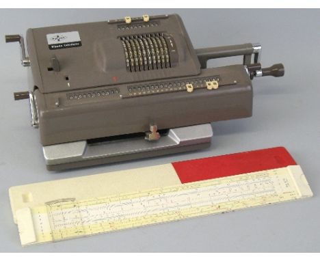 An NCM Nippon Calculator, in brown plastic case with hand cranked action, No. 261193, 35.5cm wide and an Aristo 0903LL slide 