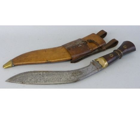 A Gurkha Kukri with 33cm steel curving blade and brass mounted hardwood grip in stitched leather wavy scabbard with frog 54.5