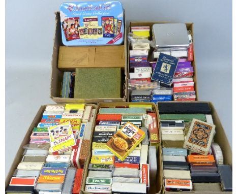 Five boxes of playing cards and playing card games, approximately one hundred and fifty packs including TV and film related, 
