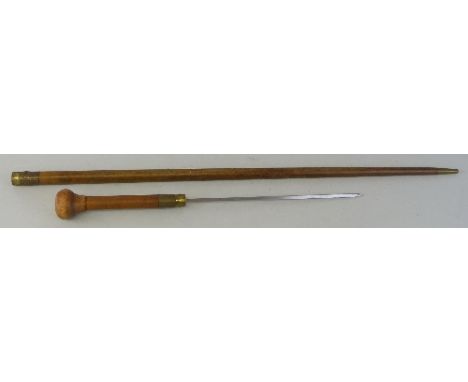 A sword stick, second half of 20th century, the 30cm steel tapering square blade concealed in a hardwood cane with bulbous te