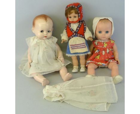 A Pedigree hard plastic baby doll with moulded hair, sleeping eyes and jointed limbs, 47cm high, a Chiltern baby doll with mo