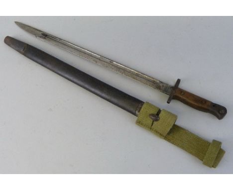 A WWI British 1907 pattern bayonet, the 43.5cm fullered steel blade inscribed Kapman (?), in leather covered scabbard with WW