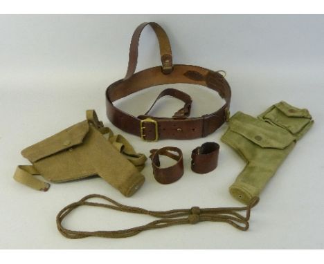 Two webbing pistol holsters, one dated 1943, the other undated but complete with attached ammunition pouch, together with a l