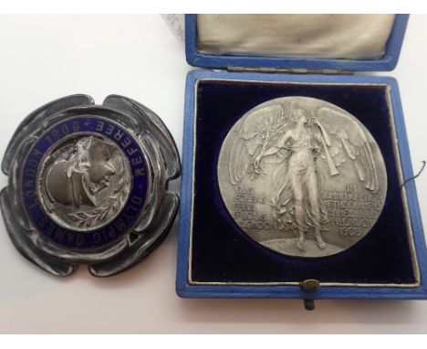 1908 Olympic games white metal and enamel referee badge and a participants medal in a referee presentation case, both struck 