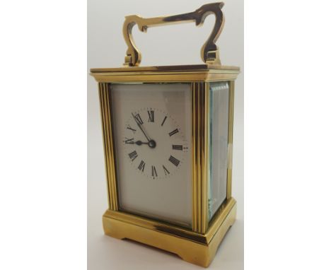Brass cased carriage clock with bevelled edge glass panels and key