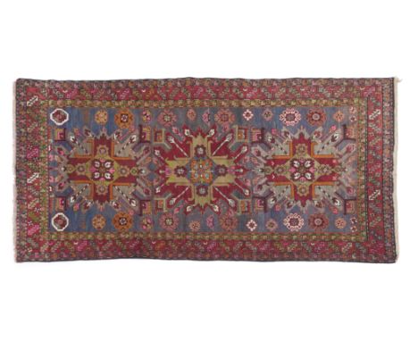 Shirwan carpet, RussianWool and cotton, featuring a geometric design in shades of green, burgundy, and pink265Ã—145 cm