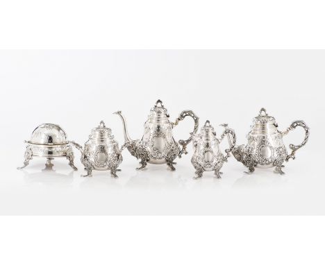 A tea and coffee serviceComprising: a teapot, coffee pot, sugar bowl, milk jug and butter dishSilver, fineness .833Relief dec