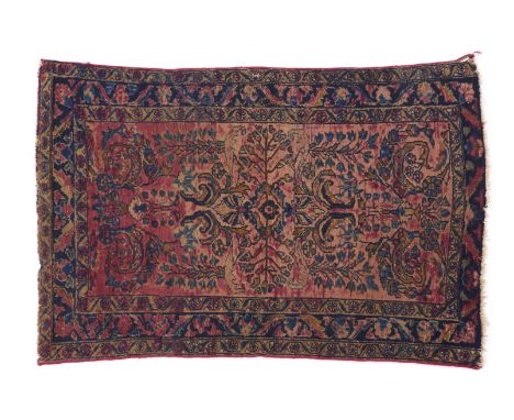 A Lilian carpet, IranIn wool and cotton_x000D_With floral design in blue, salmon and burgundy tones_x000D_(signs of wear)135Ã