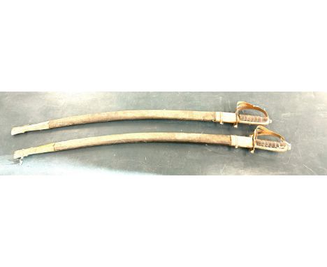 Pair of vintage decorative swords with scabbards, marked made in India on the blades 