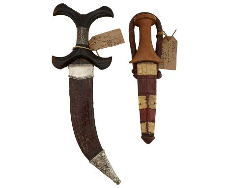 23cm double sided curved blade, dark brown carved hardwood X shaped silver wire bound hilt, contained in its tooled brown lea