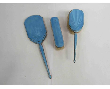 An Art Deco silver  mid blue enamel dressing table brush set, two brushes and mirror (3) marked Birmingham, slight ware