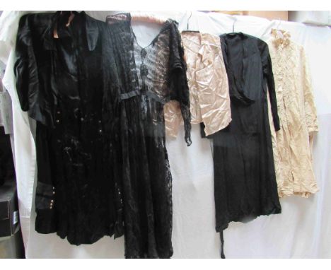 Three early 20th Century ladies black dresses, various styles, a cream raw silk coat with a stand up ruffled collar and a sle