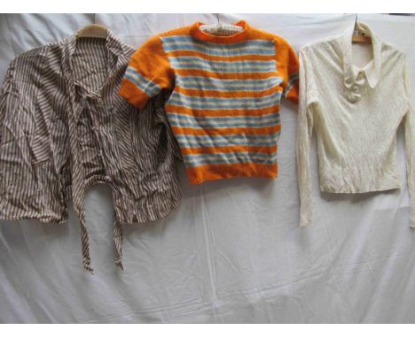 Three items of 1930's clothing, knitted orange jumper, short sleeve with bands of blue and cream, stripe blouse and cream kni