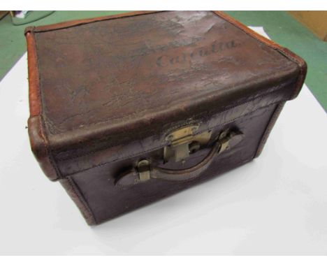 A late 19th early 2oth century vintage brown leather travelling hat box inscribed on lid J. W. Kibble Calcutta