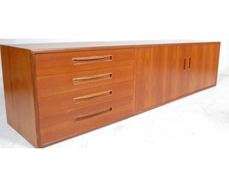 A retro vintage 20th century 1950s teak wood sideboard having a bank of four drawers to the side with lipped handles with a d