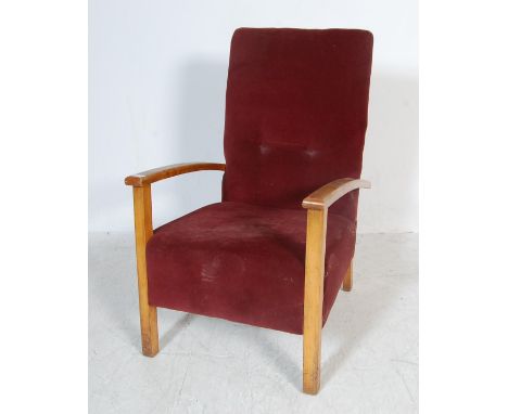 A vintage mid 20th century fireside / library /&nbsp; bedroom armchair having golden oak show wood elbow rests upholstered in