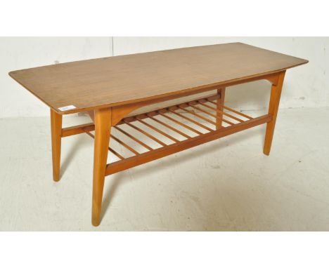 A vintage retro 20th century teak wood veneer coffee table. The coffee table of a rectangular form with ladder type magazine 