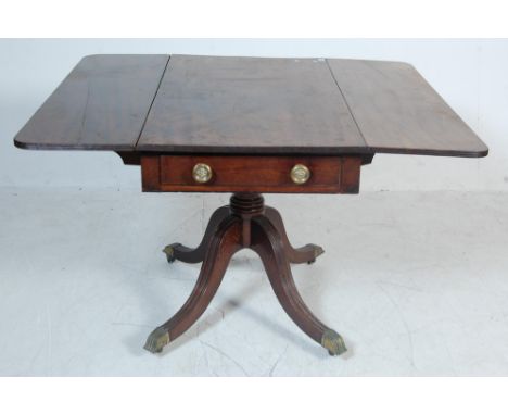 A 19th century Georgian mahogany sofa table having two drop leaves over a single drawer to the frieze with brass round handle