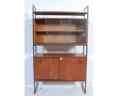 A retro vintage 1970s Avalon upright Ladderax style wall unit having two teak cupboards with lipped handles raised on metal s
