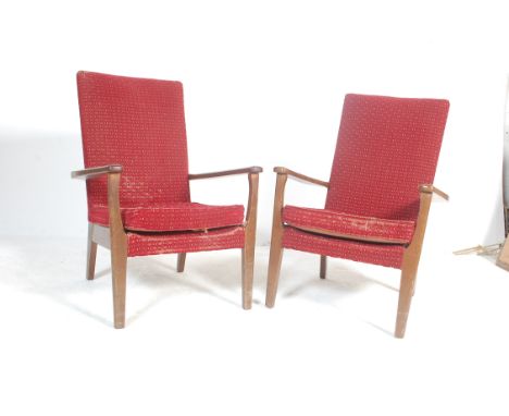 A pair of vintage retro 20th century circa 1950’s Parker Knoll armchairs / easy chairs. The chairs having red floral fabric u