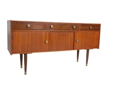 A vintage retro mid 20th century teak wood sideboard credenza . The sideboard having twin handles long drawers to the centre 