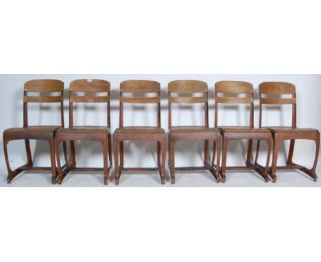 A collection of six retro vintage industrial dining chairs having faux wood metal frames,&nbsp;plywood back rest and seats ra