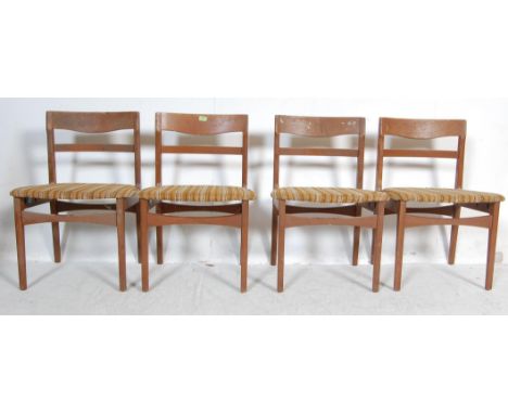 A set of four vintage retro 20th century teak wood dining chairs by nathan. The dining chairs having curved ladder backrests,