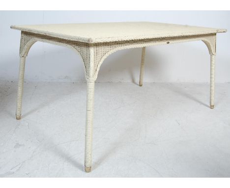 A rare vintage mid 20th century Lloyd Loom dining table. The table of a rectangular form raised on shaped legs with original 