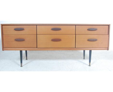 A vintage retro 20th century teak wood sideboard credenza. The sideboard of a short rectangular form having shaped handles ra