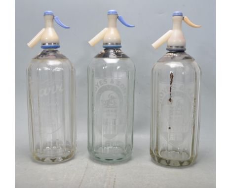 A group of three vintage advertising soda siphons each having glass bodies with faceted sides to include two Hoyes &amp; Son,