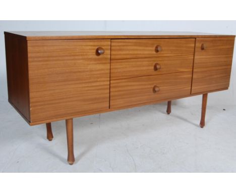 A vintage retro 20th century small proportion teak wood veneer sideboard credenza by Avalon. The sideboard having a back of t