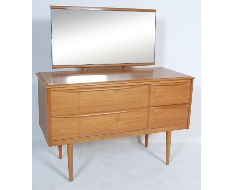 A vintage retro 20th century teak wood veneer dressing table chest. The dressing table having an adjustable mirror over a rec