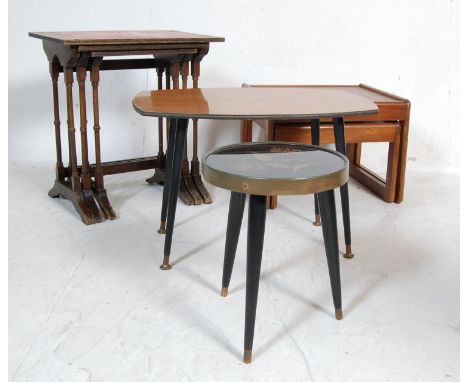 A group lot of vintage retro 20th century occasional furniture to include nest of tables, side tables raised on black tapered