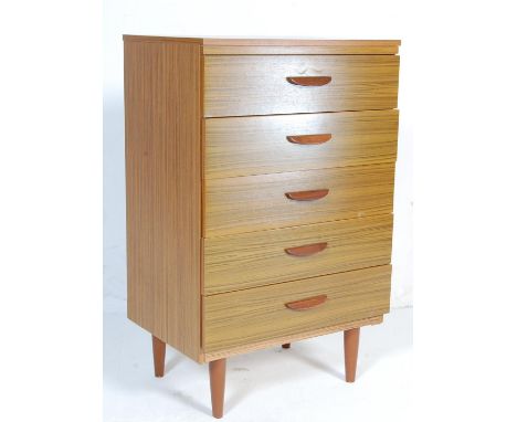 A retro vintage 20th century melamine chest of drawers having a bank of five drawers with lipped handles raised on tapering s