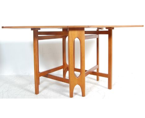 &nbsp;A retro 1960's teak wood drop leaf dining table in the manner of Mcintosh&nbsp;having square leafs with rounded corners