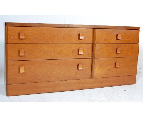 A retro vintage 20th century teak wood sideboard credenza having a bank of three drawers to the right and a larger bank of th