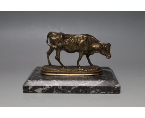 A GILT BRONZE MODEL OF A DAIRY COW,  on a champhored marble base, W 15 cm