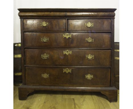 A QUEEN ANNE WALNUT CHEST OF DRAWERS, having a cushion fronted secret drawer above two short and three longer graduated drawe
