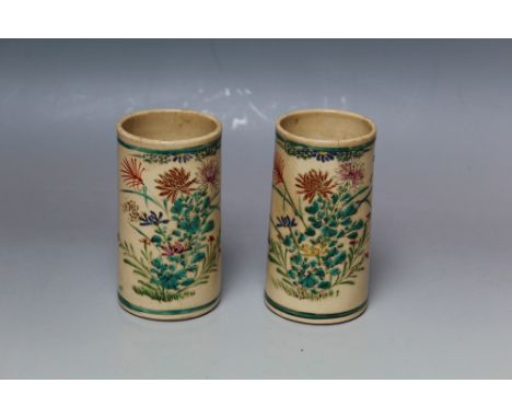 A PAIR OF ORIENTAL CERAMIC BRUSH POTS, of cylindrical form, cream ground with enamel painted decoration and three character m