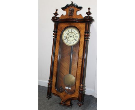 AN EARLY 20TH CENTURY WALNUT VIENNA WALL CLOCK, the enamel dial bearing maker's name but indistinct, twin weights and pendulu