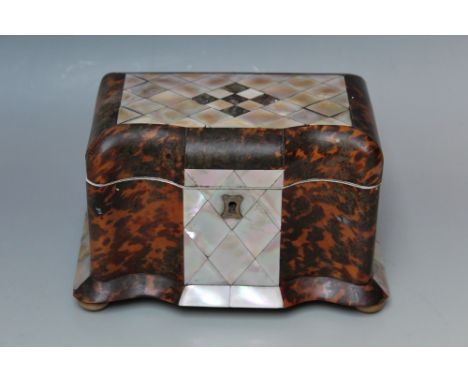 A TORTOISESHELL AND MOTHER OF PEARL TEA CADDY, having a serpentine front with twin section interior and sitting on four bun f