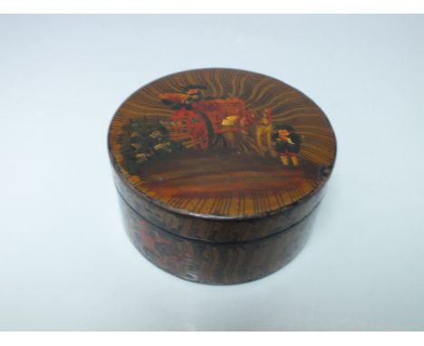 A GEORGIAN PAPIER MACHE CIRCULAR TABLE SNUFF BOX, all over decoration with figures and cart to the lid, Dia. 8.5 cm