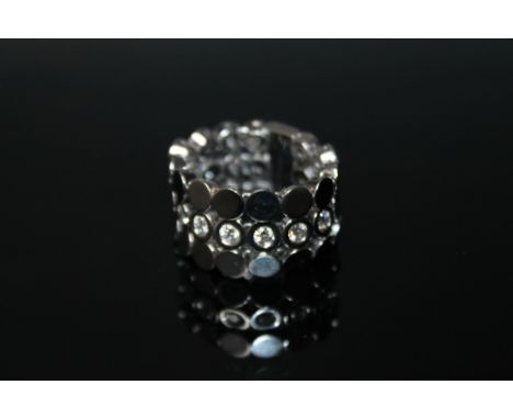 A 18 CARAT WHITE GOLD GUCCI RING,  set with 7 brilliant cut diamonds totalling approx 0.70 carat within individual hinged dis