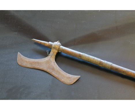 A LATE 18TH/19TH CENTURY INDIAN BULLOVA AXE, 29 cm blade attached to a 94 cm wooden shaft with wire binding, bottom spike to 