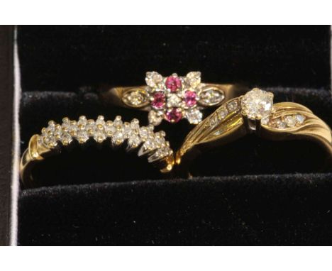 9 carat gold and diamond solitaire, 9 carat gold and diamond half eternity, and 9 carat gold, ruby and diamond ring (3)