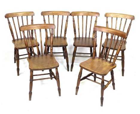 A set of six Victorian oak stick back Windsor dining chairs, with shaped seats and turned legs joined by double H stretchers,