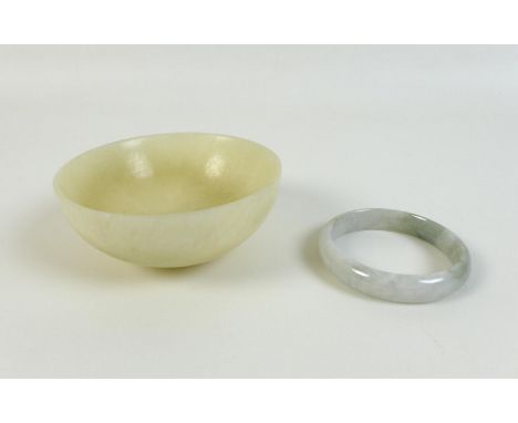 A Chinese mutton fat jade bowl, 11 by 4.5cm, together with a pale green and white jade bangle, 6cm internal, 7.3cm external d